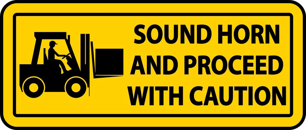 Yellow safety sign with a forklift silhouette and the text Sound Horn and Proceed With Caution